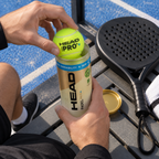 Overhead view of a player opening a tube of HEAD Padel Pro S+ balls on a courtside bench next to a racket and towel.